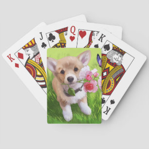 Cute little puppy with flowers in its mouth playing cards
