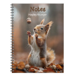Cute little squirrel catching an acorn notebook