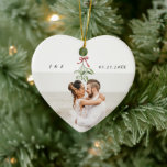 Cute Mistletoe Newlyweds Wedding Photo Monogram Ceramic Ornament<br><div class="desc">Cherish your first Christmas together with our watercolor Mistletoe Newlyweds ornament. Customised for the newlyweds' joyous memories with your favourite wedding photo as well as a cute watercolor mistletoe illustration,  your names and monogram,  and date of nuptials.🎄📸✨ #FirstChristmasJoy #PersonalizedKeepsake</div>