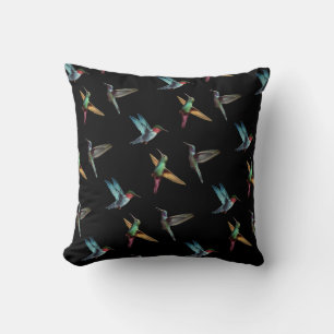 Cute multicolored hummingbirds on black cushion