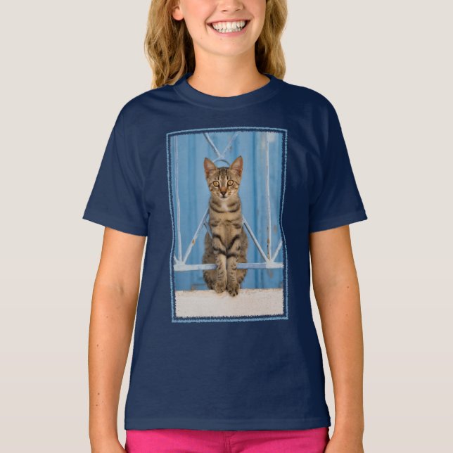 Cute Nosy Tabby Cat Kitten Sitting in a Blue Fence T-Shirt (Front)