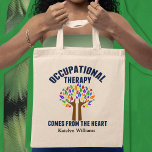 Cute Occupational Therapy Tree Personalized Tote Bag<br><div class="desc">Occupational Therapy Comes from the Heart. An inspirational OT quote gift for your occupational therapist featuring a cute tree with rainbow leaves and helping hands as the trunk of hope.</div>