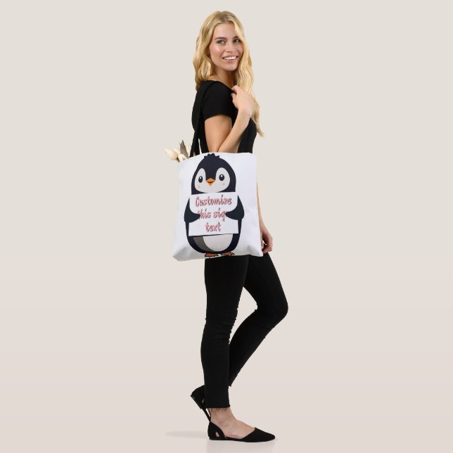 Cute penguin holding a sign for personalized text tote bag (On Model)
