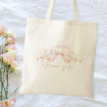 Cute Pink Bow and Wildflowers Modern Flower Girl Tote Bag<br><div class="desc">Make your flower girl feel extra special with this charming personalised t-shirt! Featuring a delicate floral design and a sweet bow, this shirt is perfect for adding a touch of elegance to your wedding party. Customise it with her name to create a keepsake she'll cherish forever. Crafted from soft, comfortable...</div>