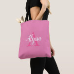 Cute Pink White Script Monogram Tote Bag<br><div class="desc">Cute Pink White Script Monogram Tote Bag featuring an elegant arrangement of name (in white) and monogram initial (in hot pink) on a pretty pink background. The bag is easy to personalise by typing the name and initial of your choice into the online personalisation template before ordering. The text automatically...</div>