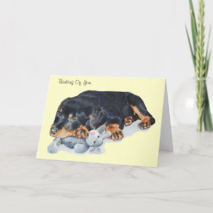 cute puppy rottweiler dog cuddling teddy bear art card