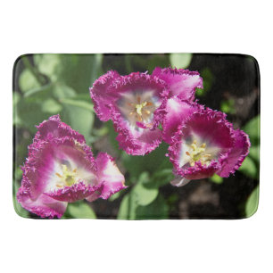 Cute purple  tulips  in the garden  bath mat