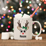 Cute Reindeer Girl Green Bow Custom Name Christmas Coffee Mug<br><div class="desc">Cute and girly Christmas coffee or hot cocoa mug features an illustration of a sweet Rudolph reindeer girl face with a shiny red nose, eyelashes, and antlers. She is dressed up with a green bow and surrounded by light grey snowflakes. Personalise this festive hot chocolate mug with a first name...</div>