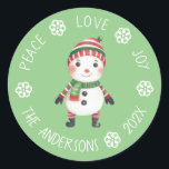 Cute Snowman Peace Love Joy Snowflake Christmas Classic Round Sticker<br><div class="desc">Recommended as a  seal for the envelope of a Christmas greeting card.

A cute little snowman on light green background surrounded by arched text with white snowflakes between words.</div>