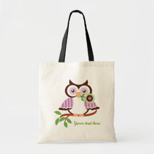 Cute spring owl holding a flower in her beak tote bag