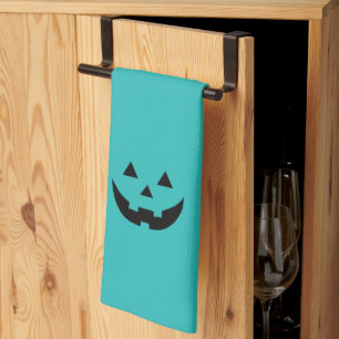 Cute teal jack o lantern pumpkin face Halloween Tea Towel