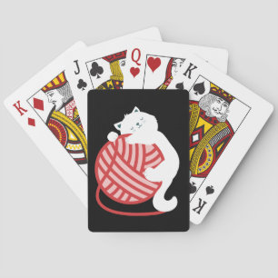 Cute white cat with yarn ball playing cards