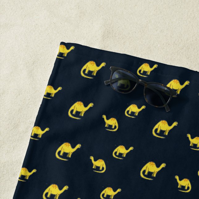 Cute yellow dinosaurs pattern on blue beach towel (In Situ)