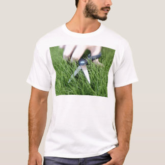 Cutting the grass with a pair of scissors T-Shirt