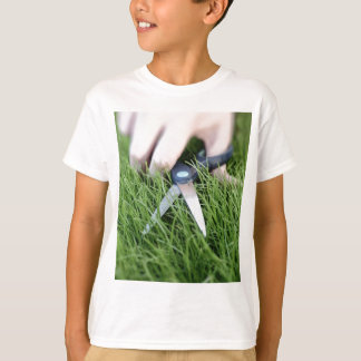 Cutting the grass with a pair of scissors T-Shirt