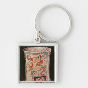 Cylindrical depicting a deity with speech curls key ring