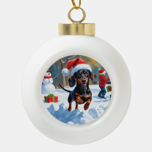Dachshund Running in Snow with Christmas Hat Ceramic Ball Christmas Ornament (Front)