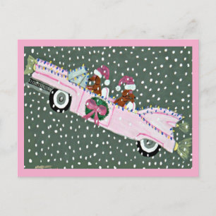 Dachshunds at Christmas in a pink convertible Postcard