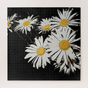 Daisies bloom on black decor. jigsaw puzzle