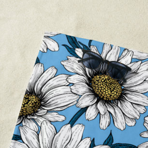 Daisies, wild flowers on blue beach towel
