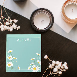 Daisy flower frame on light green background notepad