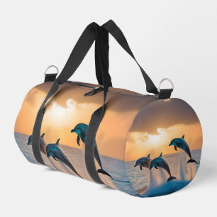 Dancing in the Dusk: Three Dolphins Leaping Duffle Bag