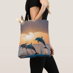 Dancing in the Dusk: Three Dolphins Leaping  Tote Bag