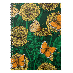 Dandelion meadow on dark green notebook