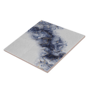 Dark blue and gold watercolor ink marks ceramic tile