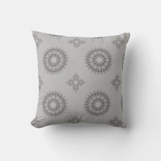 dark grey, intricate mandala-like designs against cushion