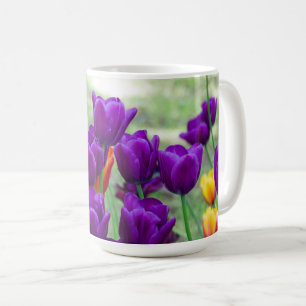 Dark purple tulips on a sunny day in the garden coffee mug