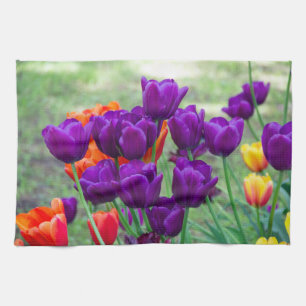 Dark purple tulips on a sunny day in the garden tea towel