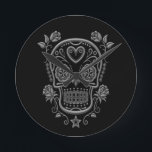 Dark Sugar Skull with Roses on Black Round Clock<br><div class="desc">This stunning design features a Day of the Dead sugar skull on a pure black background. Four roses surround the skull with delicate vines flowing down to a five point star at the base of the pattern. A large heart sits in the middle of the forehead with fluid swirls on...</div>