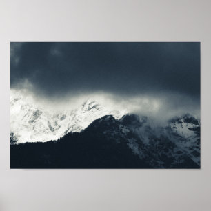 Darkness and light on snow covered mountains poster