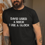 David Used a Rock I use a Glock T-Shirt<br><div class="desc">This design may be personalised in the area provided by changing the photo and/or text. Or it can be customised by clicking Personalise this Template and then choosing the click to customise further option and delete or change the colour of the background, add text, change the text colour or style,...</div>