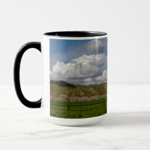 Decorative mug with landscape and clouds