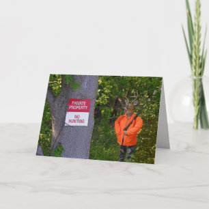 deer hunter in woods with sign card