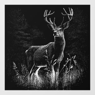 Deer with antlers framed by field and tree  