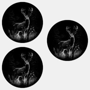 Deer with antlers framed by field and tree      