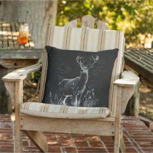 Deer with antlers framed by field and tree     cushion