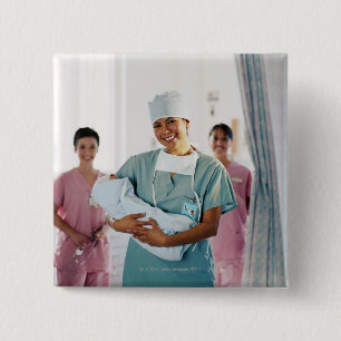 Delivery room nurse holding baby, nurses in 15 cm square badge