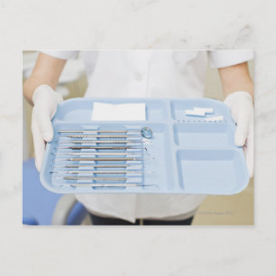 Dental hygienist  holding tray of dental postcard