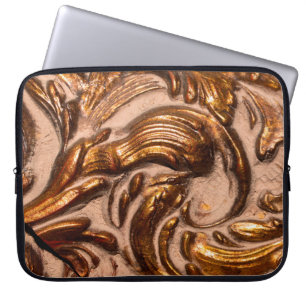 detail of ornamental picture frame, bronze colour. laptop sleeve