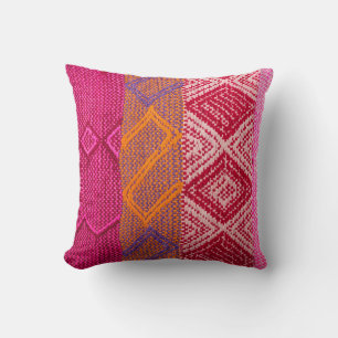 Details shot of indian fabric with colourful patte cushion