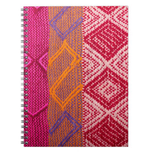 Details shot of indian fabric with colourful patte notebook