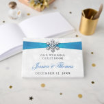 Diamante Snowflake & Blue Ribbon Winter Wedding Guest Book<br><div class="desc">Celebrate in style with this glamourous and very trendy real foil pressed wedding guestbook. The design is easy to personalise with your special event wording and your guests will be thrilled when they see this fabulous guestbook. Matching wedding items can be found in the collection.</div>