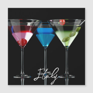 Different cocktails in martini glasses on black