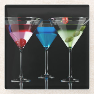 Different cocktails in martini glasses on black glass coaster