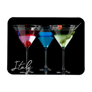 Different cocktails in martini glasses on black magnet