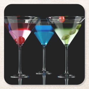 Different cocktails in martini glasses on black square paper coaster